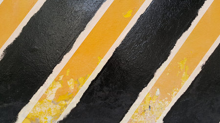 Footpath black and yellow color with brick wall background with free space  : Traffic signs...