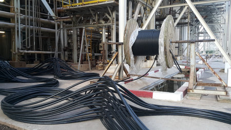 Black wire electric cable with wooden coil of electric cable .prepare for connect to power supply