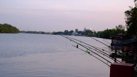 Riverside pier and fishing in sunset light on  river side atの写真素材