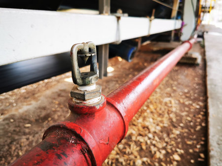Brass springer nozzle on pipe under belt conveyor for fire fighting system.