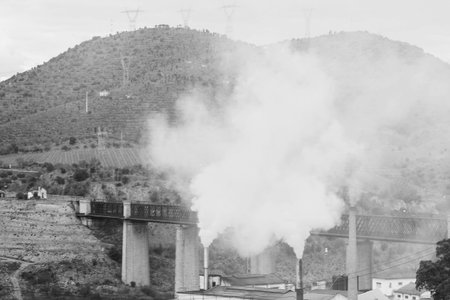 Black and white factory pollution nearly mountain