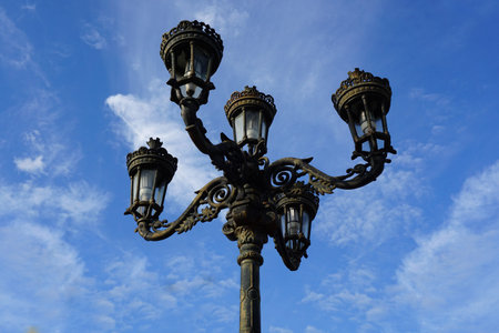 Top of street lamp against blue sky
