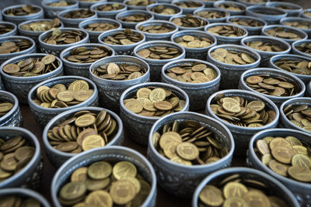 Golden coin in silver bowls for donation, Temple of Thailandの写真素材