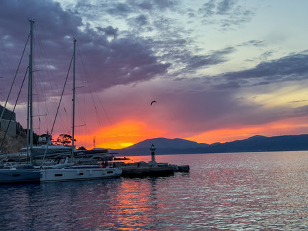 Yachts Moored in Hydra Port at Sunset with Lighthouseの写真素材