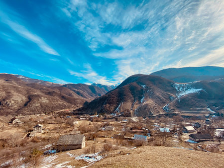 Mountain village under blue sky with white clouds. Beautiful landscape.の写真素材