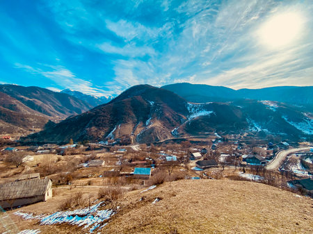 Beautiful winter landscape with snow-capped mountains and village.の写真素材