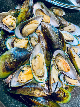 Fresh mussels cooked on a grill pan. Seafood background.の写真素材
