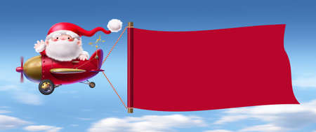 Santa flies the plane and pulls the red cloth.の写真素材