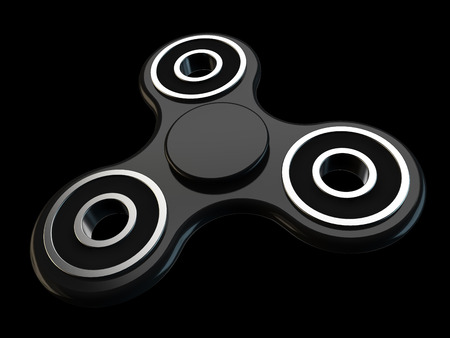 Fidget spinner stress relieving toy on black backgroundの写真素材