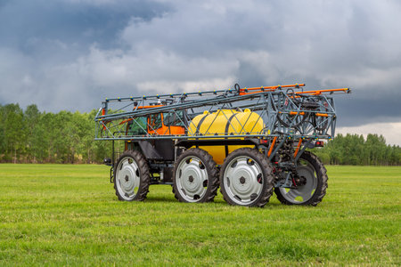 Russia, Leningrad Region - June, 2019: Tractor with equipment for spraying plants. Agricultural...