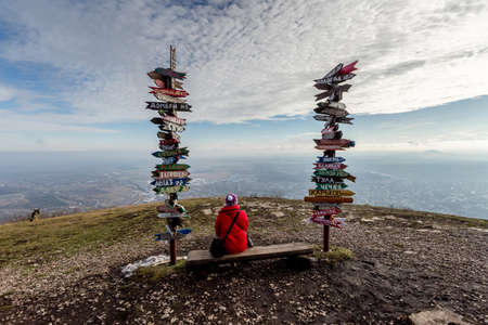 Caucasus, Pyatigorsk, Russia: Landscape on the mountain post with pointers cities and wooden bench on the peakのeditorial素材
