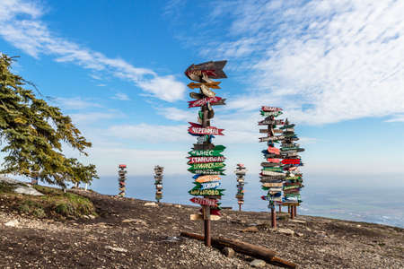 Caucasus, Pyatigorsk, Russia: Landscape on the mountain post with pointers cities and wooden bench on the peakのeditorial素材