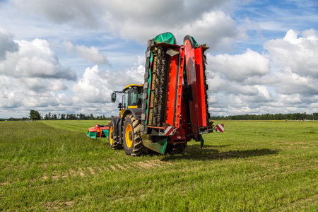 Russia, Leningrad Region - June, 2019: Powerful tractor and rotary rakes at the exhibitionのeditorial素材
