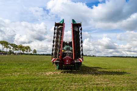 Russia, Leningrad Region - June, 2019: Powerful tractor and rotary rakes at the exhibitionのeditorial素材