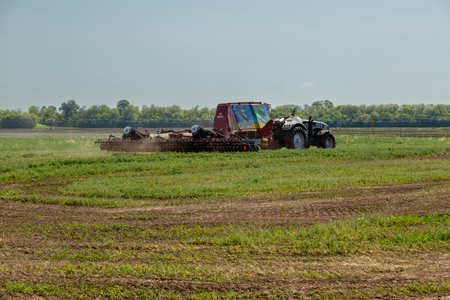 Russia, Republic of Tatarstan, Kazan - July, 2022: Autonomous tractor working in the field. Smart farming and digital transformation in agricultureのeditorial素材