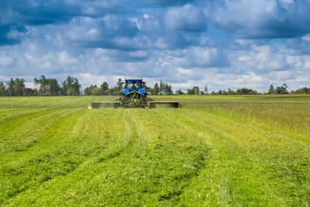 Russia, Leningrad Region - June, 2019: Powerful tractor and rotary rakes at the exhibitionのeditorial素材