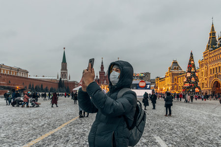 A person takes a photo on their phone on Red Squareの写真素材