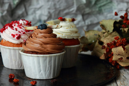 Chocolate cupcakes on a background of vanilla and raspberry