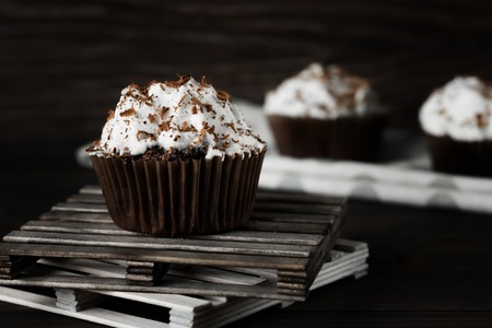 Chocolate-coffee cupcakes on a dark wooden backgroundの写真素材