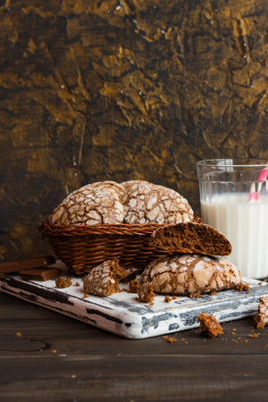 Chocolate biscuits with cracks on a dark wooden background