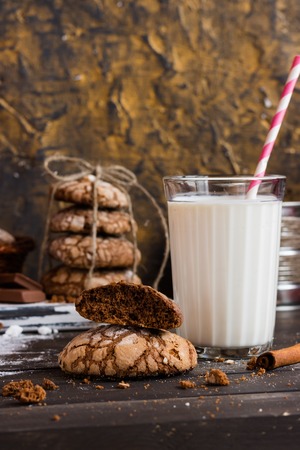 Chocolate biscuits with cracks on a dark wooden backgroundの写真素材