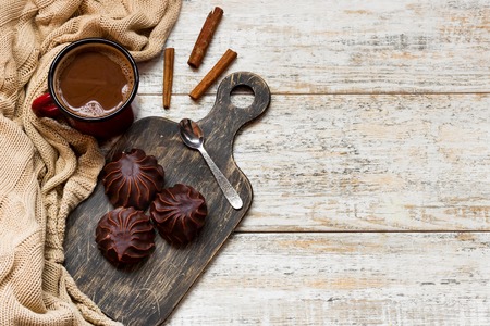 Marshmallow in chocolate on a wooden backgroundの写真素材
