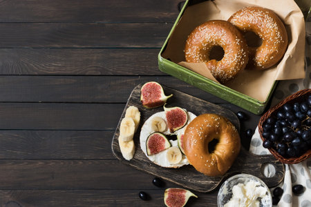 Bagels with fig and banana on curd cheese for breakfast