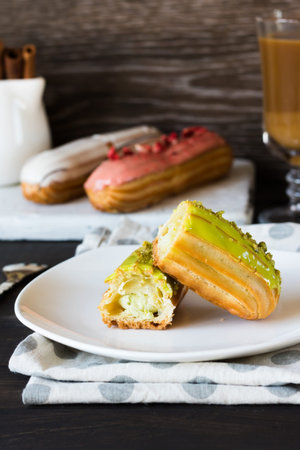Pistachio, vanilla, strawberry eclair in glaze