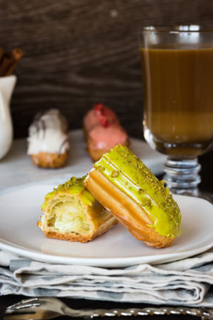 Pistachio, vanilla, strawberry eclair in glaze