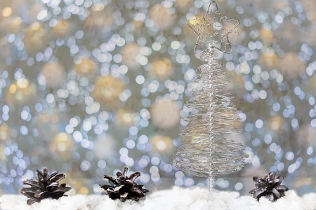 Christmas tree made of wire against the background of fir branches. Color bokehの写真素材