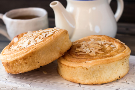 Denihs with almond petals on a white plate on a light backgroundの写真素材