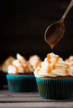 Cupcakes with caramel cream on a dark backgroundの写真素材