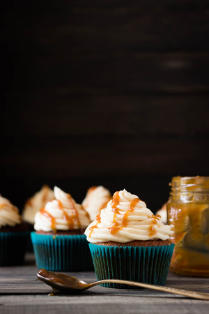 Cupcakes with caramel cream on a dark backgroundの写真素材