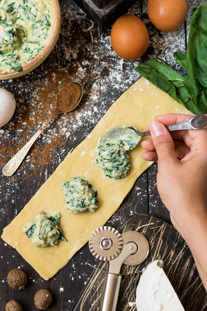 The process of making ravioli with ricotta, spinach and nutmegの写真素材