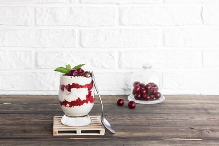 Light berry dessert. Trifle red velvet with cherry and cream cheeseの写真素材