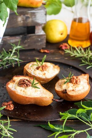 Baked pears with ricotta, walnuts and honey. Light healthy dessert without sugar. A warming dish.の写真素材