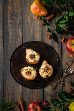 Baked pears with ricotta, walnuts and honey. Light healthy dessert without sugar. A warming dish.の写真素材