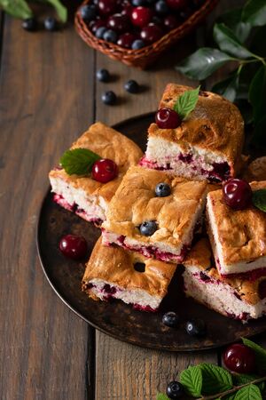 Traditional Russian pie Charlotte with fresh seasonal berriesの写真素材