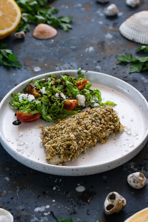 Baked seabass spicy breading with fresh salad. An example of a balanced lunch. The concept of proper...