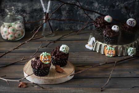 Chocolate Cupcakes with Chocolate Cream Decorated with Creepy Marshmallow Sweets for Halloween Party. Halloween food.の写真素材