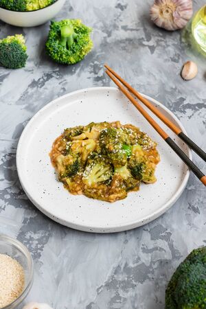 Fried broccoli in a thick garlic sauce. Asian food. Vegetarian dish.の写真素材