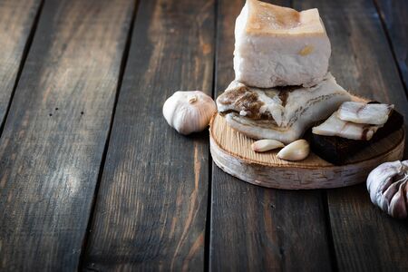 Salted pork lard on a dark wooden background.の写真素材