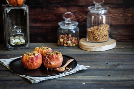 Baked apples with nut granola and pumpkin seeds. A wholesome and simple dessertの写真素材