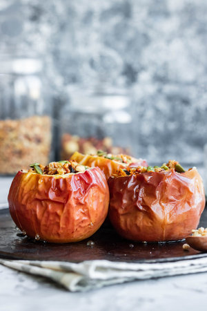 Baked apples with nut granola and pumpkin seeds. A wholesome and simple dessertの写真素材