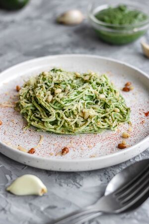 Green vegan pasta with avocado, spinach and pine nuts. Healthy and wholesome food. Good nutrition.の写真素材