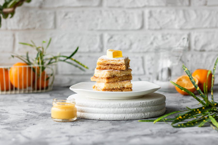 Homemade lemon bars on the oven dough. Light summer lemon dessert.