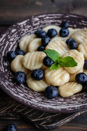 Lazy cottage cheese dumplings with fresh berry. Simple and wholesome breakfast. National Ukrainian cuisineの写真素材