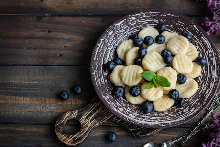 Lazy cottage cheese dumplings with fresh berry. Simple and wholesome breakfast. National Ukrainian cuisineの写真素材