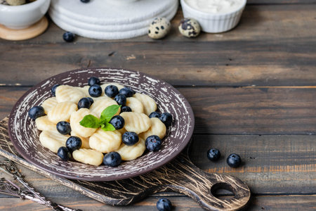 Lazy cottage cheese dumplings with fresh berry. Simple and healthy breakfastの写真素材