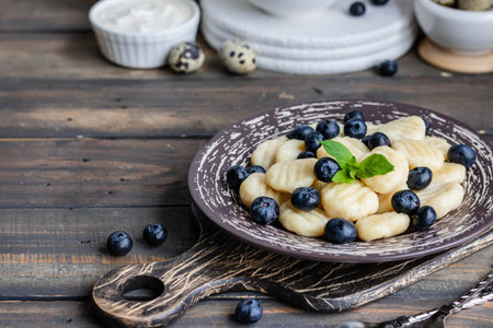 Lazy cottage cheese dumplings with fresh berry. Simple and healthy breakfastの写真素材